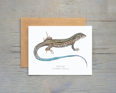 Greeting card with a lizard illustration on a wooden surface