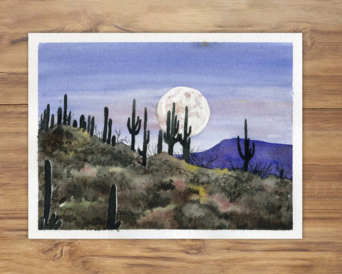 A watercolor painting of a full moon rising over a desert landscape with cacti.